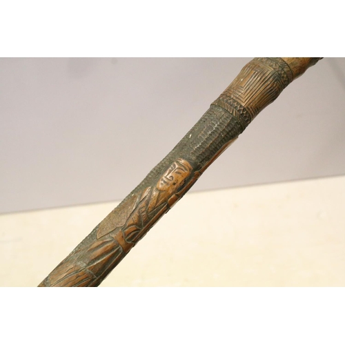 134 - Collection of five oriental carved walking cane stagger sticks with elaborate carvings and intricate... 