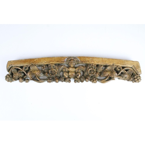 139 - 17th century carved wood curved decorative piece with nude, flowers and berry detail together with 1... 