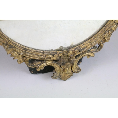 150 - Carved wood oval beveled gilded mirror with ribbon and bow detail, 41cm high x 28cm wide