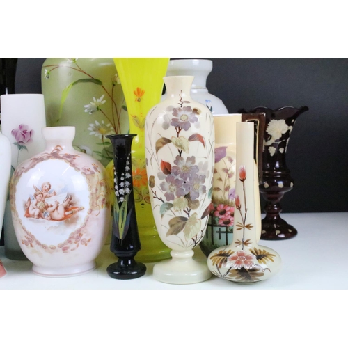 53 - Selection of Victorian hand painted floral decorative glass vases in various sizes and shapes, to in... 