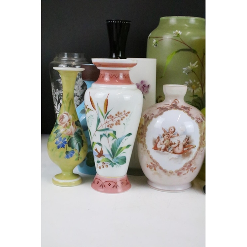 53 - Selection of Victorian hand painted floral decorative glass vases in various sizes and shapes, to in... 