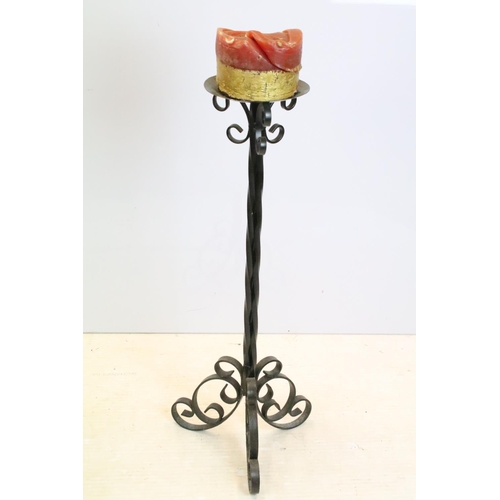 596 - Cast iron torchere candle stand having round dish to top raised on a scrolled iron tripod base. Meas... 