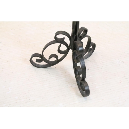 596 - Cast iron torchere candle stand having round dish to top raised on a scrolled iron tripod base. Meas... 