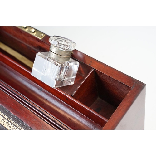 128 - Mahogany writing slope box with brass handles and inlay detailing, complete with two inkwells, two l... 