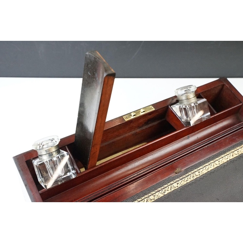 128 - Mahogany writing slope box with brass handles and inlay detailing, complete with two inkwells, two l... 