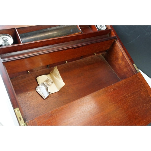 128 - Mahogany writing slope box with brass handles and inlay detailing, complete with two inkwells, two l... 