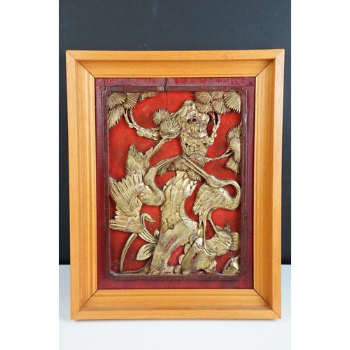 142 - 19th Century Chinese carved panels in red and gold depicting birds, flowers, storks and dragons in v... 