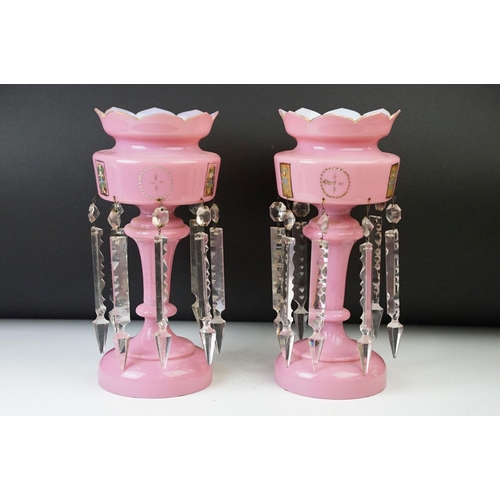 17 - Pair of Victorian pink glass lustres with painted floral decoration and prismatic drops. 31cm tall.