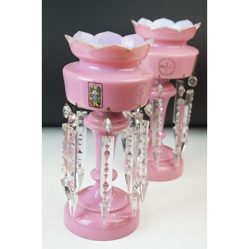 17 - Pair of Victorian pink glass lustres with painted floral decoration and prismatic drops. 31cm tall.