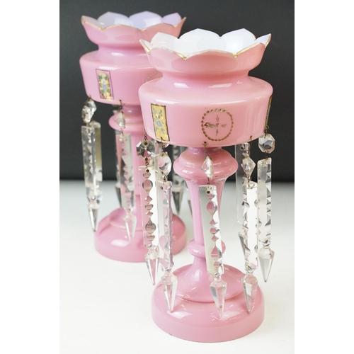 17 - Pair of Victorian pink glass lustres with painted floral decoration and prismatic drops. 31cm tall.