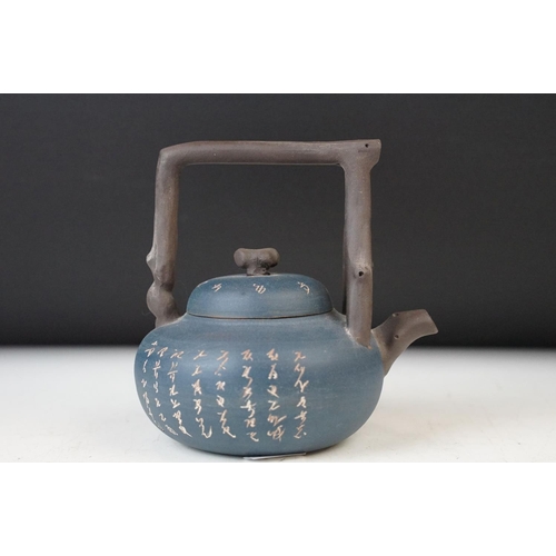 24 - Dark blue Chinese small handmade clay teapot kettle with inscriptions and branch design handle. Sign... 