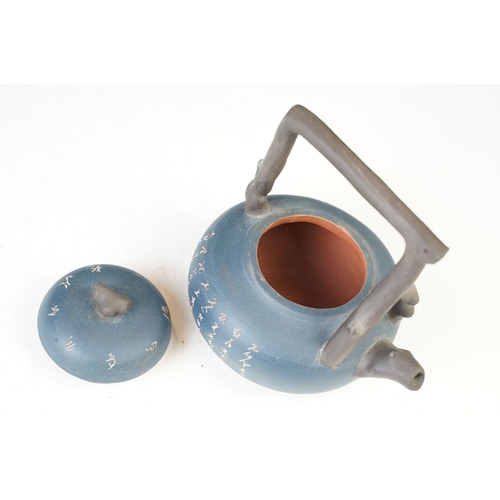 24 - Dark blue Chinese small handmade clay teapot kettle with inscriptions and branch design handle. Sign... 