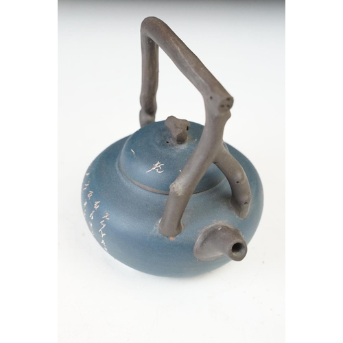 24 - Dark blue Chinese small handmade clay teapot kettle with inscriptions and branch design handle. Sign... 