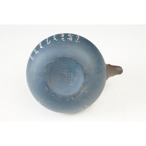 24 - Dark blue Chinese small handmade clay teapot kettle with inscriptions and branch design handle. Sign... 