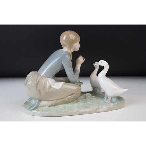 27 - Collection of three Lladro figurines of girls with geese and a lamb, 30cm tallest, all stamped at ba... 