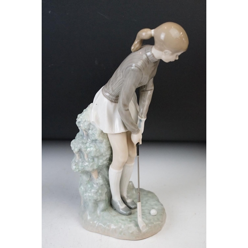 38 - Lladro porcelain figurines of girl playing golf, 27.5cm tall and turtle dove in flight 28cm tall. Ma... 