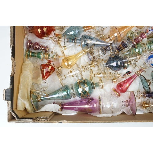 45 - Collection of 20th century coloured glass scent bottles in varying sizes and shapes with intricate d... 