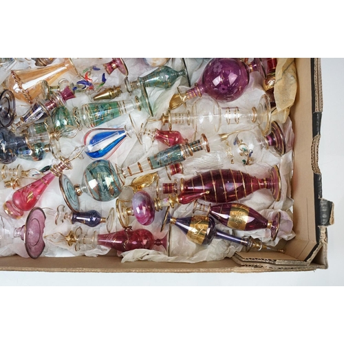 45 - Collection of 20th century coloured glass scent bottles in varying sizes and shapes with intricate d... 