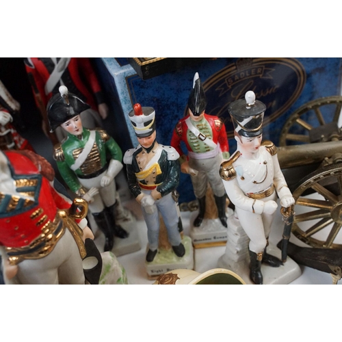 81 - Two small table canons and a selection of historical and military figurines, Duke of Wellington, Nap... 