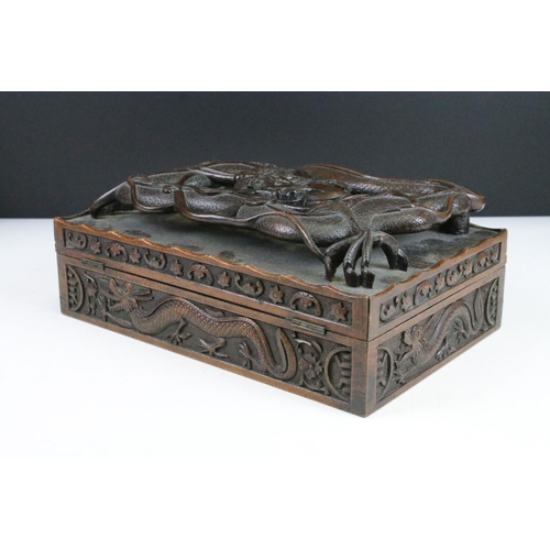 102 - Intricately carved dragon table top box with raised relief dragon to lift up top and carved dragon d... 