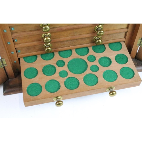 107 - Table top cabinet for coin collecting with ten drawers with assorted sized felt lined coin spacers, ... 