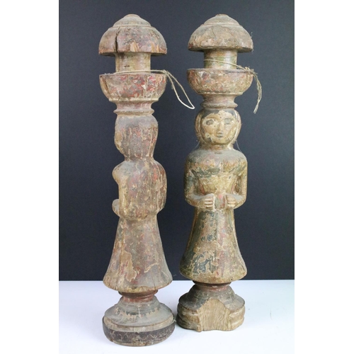 109 - Carved wooden pair of ceremonial painted figures of women, one with metal base surround. 44cm tall.