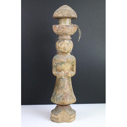 109 - Carved wooden pair of ceremonial painted figures of women, one with metal base surround. 44cm tall.