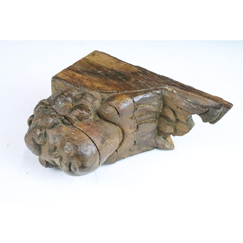 119 - Carved wood head of cherub with feathers detail wall bracket 16cm high x 8cm wide x 13cm deep with a... 