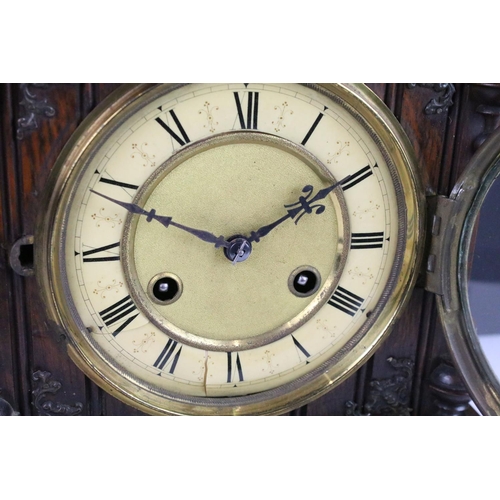 121 - Antique mantel clock with attractive carved wood case, complete with key. 50cm high, 27cm wide and 1... 