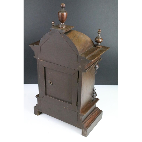 121 - Antique mantel clock with attractive carved wood case, complete with key. 50cm high, 27cm wide and 1... 