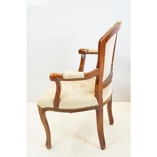 600 - Pair of 20th Century arm chairs having carved wooden framed with floral upholstered seats.