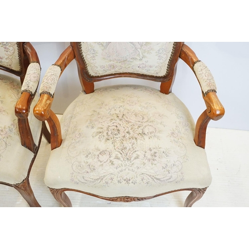 600 - Pair of 20th Century arm chairs having carved wooden framed with floral upholstered seats.