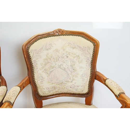 600 - Pair of 20th Century arm chairs having carved wooden framed with floral upholstered seats.