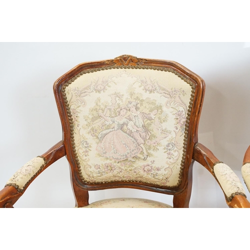 600 - Pair of 20th Century arm chairs having carved wooden framed with floral upholstered seats.