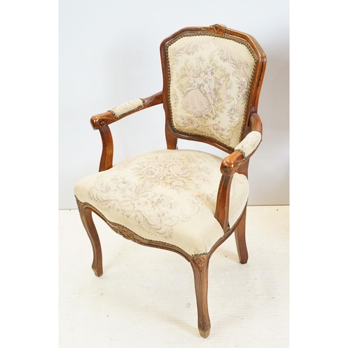 600 - Pair of 20th Century arm chairs having carved wooden framed with floral upholstered seats.