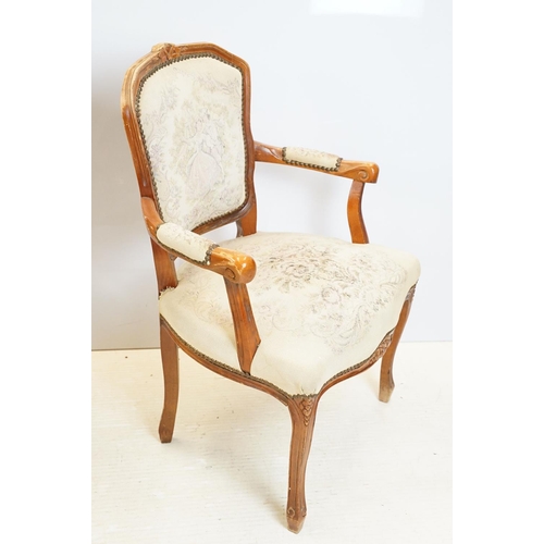 600 - Pair of 20th Century arm chairs having carved wooden framed with floral upholstered seats.