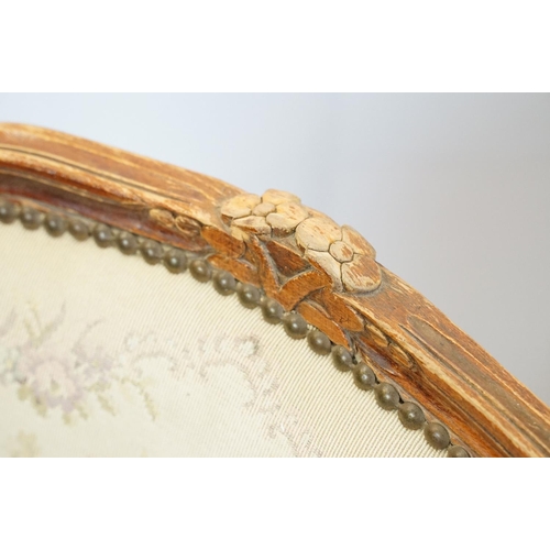 600 - Pair of 20th Century arm chairs having carved wooden framed with floral upholstered seats.