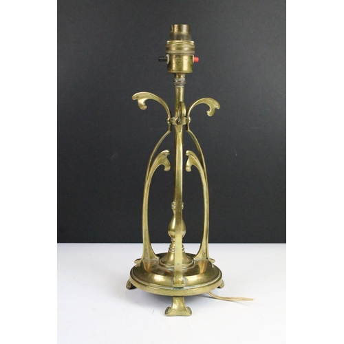 313 - Victorian Art Nouveau ornate brass table lamp,  circular base on three scroll feet. 35cm tall.