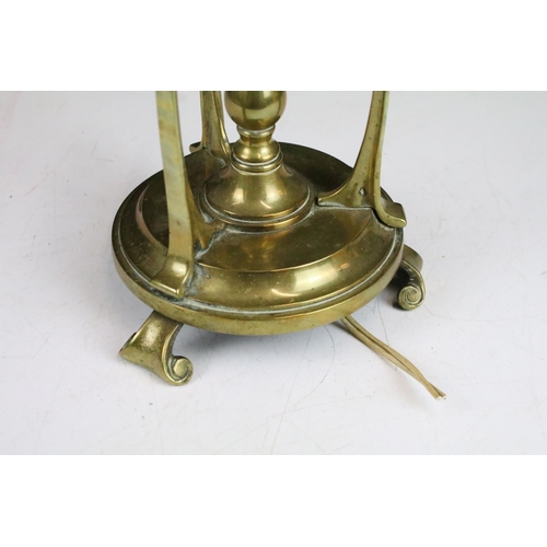 313 - Victorian Art Nouveau ornate brass table lamp,  circular base on three scroll feet. 35cm tall.