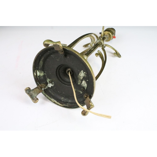 313 - Victorian Art Nouveau ornate brass table lamp,  circular base on three scroll feet. 35cm tall.