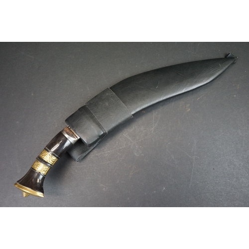 104 - A 3 Chirre / Fuller bladed Kukri knife, steel blade, horn handle with double brass banding, leather ... 