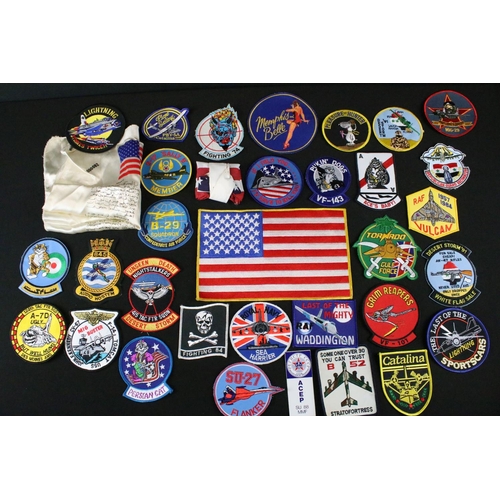 148 - A large collection of reproduction military and air force cloth badges and patches.