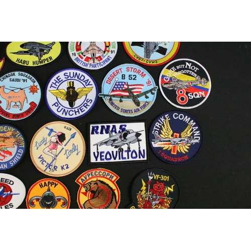 148 - A large collection of reproduction military and air force cloth badges and patches.