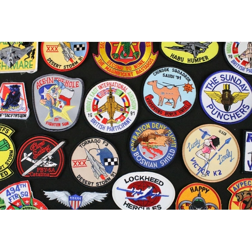 148 - A large collection of reproduction military and air force cloth badges and patches.