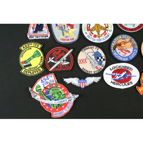 148 - A large collection of reproduction military and air force cloth badges and patches.