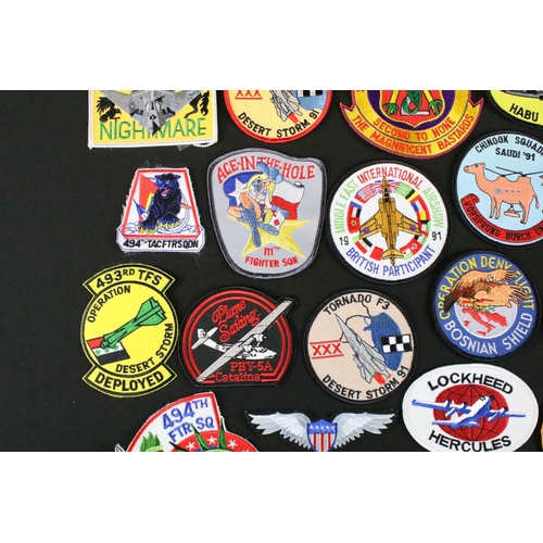 148 - A large collection of reproduction military and air force cloth badges and patches.