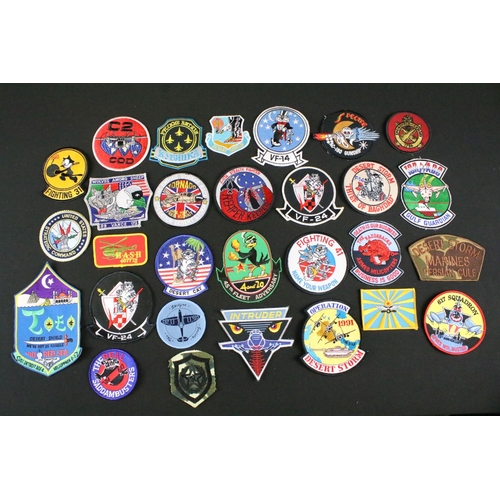 148 - A large collection of reproduction military and air force cloth badges and patches.