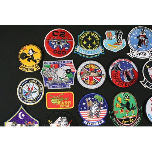 148 - A large collection of reproduction military and air force cloth badges and patches.