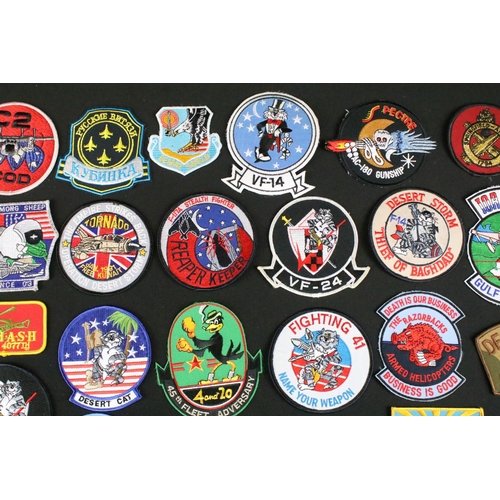 148 - A large collection of reproduction military and air force cloth badges and patches.