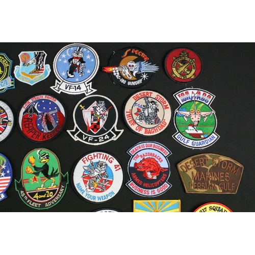 148 - A large collection of reproduction military and air force cloth badges and patches.